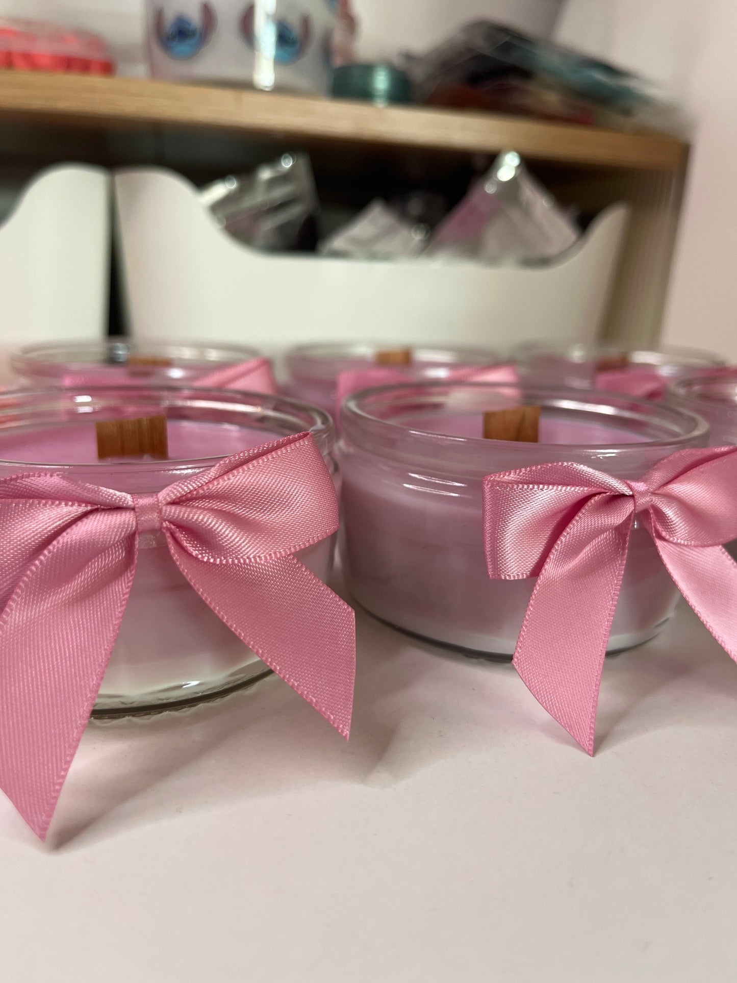 Pink&white Woodwick candles in the scent “Black Cherry”