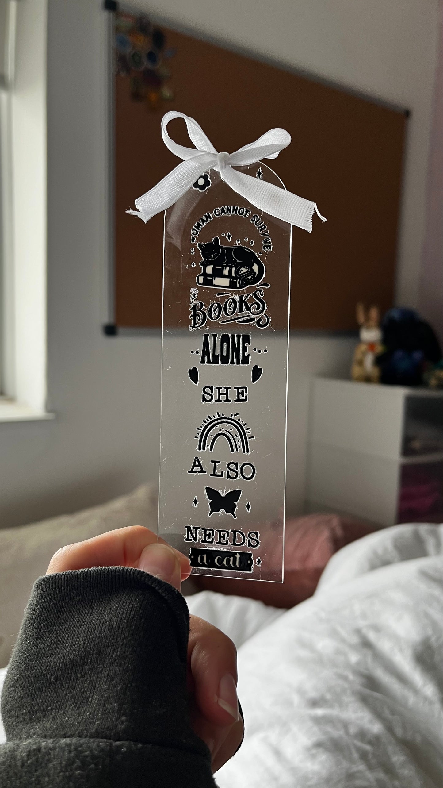 “A woman cannot survive books alone, she also needs a cat” bookmark